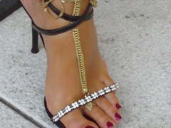 1 Sexy black sandals enhanced by gold barefoot sandals.